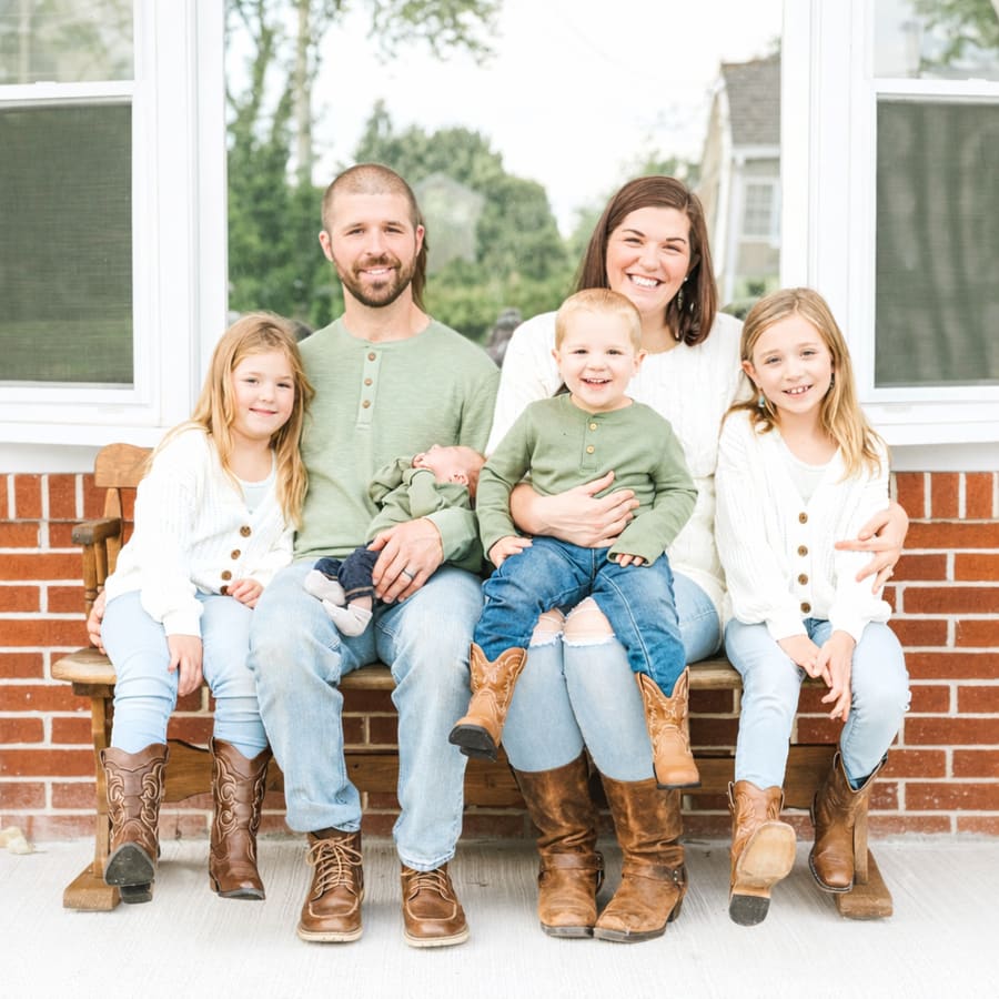 The family behind E&A Mechanical on their front porch bench